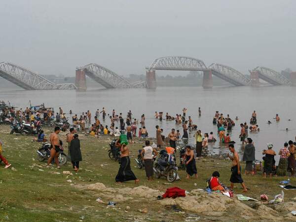 AFP PICTURES OF THE YEAR 2025

People bathe in the Irrawaddy River in front of the collapsed Ava Bridge, also known as the Inwa Bridge, in Sagaing on April 2, 2025, as residential areas remain without electricity or running water five days after a major earthquake struck central Myanmar.. The shallow 7.7-magnitude earthquake on March 28 flattened buildings across Myanmar, killing nearly 3,000 people and making thousands more homeless. (Photo by Sai Aung MAIN / AFP) / AFP PICTURES OF THE YEAR 2025