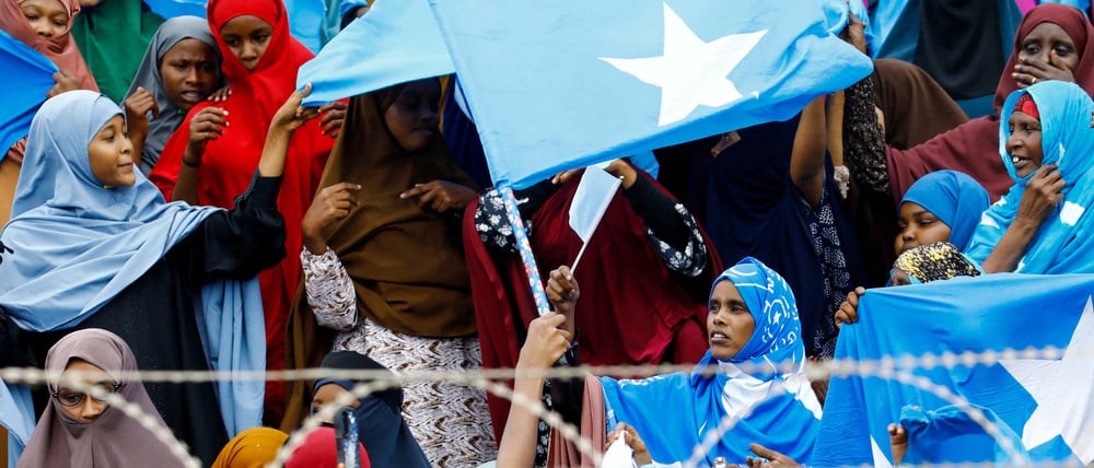 Women wave Somali national flags, as they attend a demonstration after Israel became the first country to formally recognize the self-declared Republic of Somaliland as an independent and sovereign state, a decision that could reshape regional dynamics and test Somalia's longstanding opposition to secession, at the Mogadishu Stadium in Warta Nabada district of Mogadishu, Somalia December 30, 2025. REUTERS/Feisal Omar