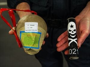 Ein Polizeibeamter vom Landeskriminalamt hält 2016 in Mainz zwei illegale Feuerwerkskörper, eine Kugelbombe und einen Böller mit Totenkopf, in seinen Händen. (Symbolbild)