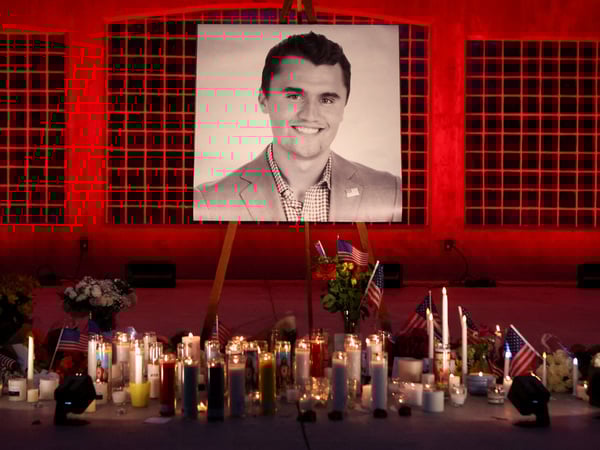 FILE PHOTO: Candles and flowers are placed near an image of Charlie Kirk, during a vigil at Orem City Center Park, after U.S. right-wing activist and commentator, Charlie Kirk, an ally of U.S. President Donald Trump, was fatally shot during an event at Utah Valley University, in Orem, Utah, U.S. September 11, 2025.  REUTERS/Jim Urquhart/File Photo