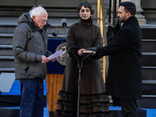 NEW YORK, NEW YORK - JANUARY 01: Sen. Bernie Sanders (I-VT) swears in Mayor Zohran Mamdani at the ceremonial inauguration at City Hall Thursday January 1, 2026 in New York, NY. Mamdani has added a "block party" to the official inauguration events to allow thousands of New Yorkers to take part. Mamdani was officially sworn in at midnight by New York Attorney General Letitia James at the Old City Hall subway station in a private ceremony.   David Dee Delgado/Getty Images/AFP (Photo by David Dee Delgado / GETTY IMAGES NORTH AMERICA / Getty Images via AFP)
