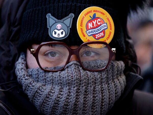A person attends the Inauguration for a New Era Block Party in New York City on January 1, 2026 as Mayor Zohran Mamdani takes office. Mamdani, the young upstart of the US left, was sworn in Thursday to take over as New York mayor for a term sure to see him cross swords with President Donald Trump. After the clocks struck midnight, bringing in 2026, Mamdani took his oath of office at an abandoned subway stop to begin managing the United States' largest city. He is New York's first Muslim mayor. (Photo by Leonardo Munoz / AFP)