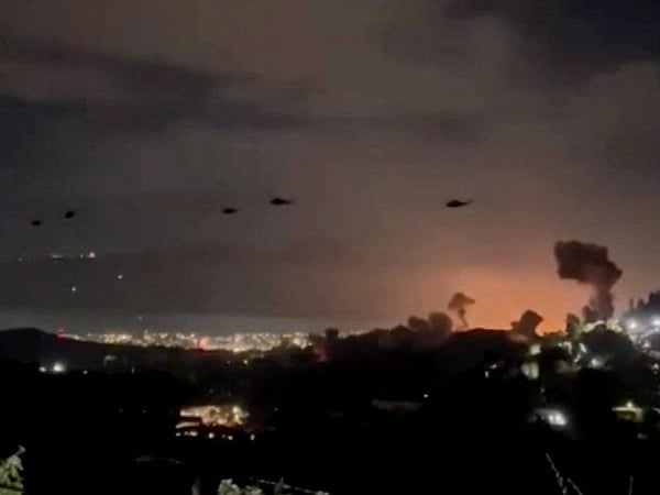 Helicopters fly past plumes of smoke rising from explosions, in Caracas, Venezuela, January 3, 2026 in this screen grab obtained from video obtained by Reuters. Video Obtained by Reuters/via REUTERS  THIS IMAGE HAS BEEN SUPPLIED BY A THIRD PARTY. NO RESALES. NO ARCHIVES. NEWS USE ONLY. THIS PICTURE WAS PROCESSED BY REUTERS TO ENHANCE QUALITY. AN UNPROCESSED VERSION HAS BEEN PROVIDED SEPARATELY.

VERIFICATION:
- Mountains, towers and buildings match satellite and file imagery of Caracas 
- Date verified by multiple corroborating videos of strikes on Caracas      TPX IMAGES OF THE DAY     