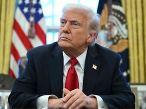 (FILES) US President Donald Trump announces tariffs on auto imports in the Oval Office of the White House in Washington, DC, on March 26, 2025. Venezuela on January 3, 2026, demanded an emergency meeting of the UN Security Council to discuss the US military strikes on the country, amid uncertainty over the whereabouts of President Nicolas Maduro, after President Donald Trump said that US forces had captured the Venezuelan leader after launching a "large scale strike" on the South American country. (Photo by Mandel NGAN / AFP)