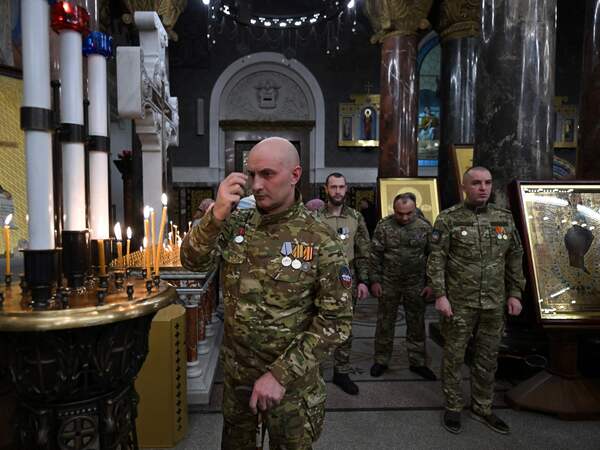 Russian servicemen, involved in the so-called 'special military operation' in Ukraine,  attend a Christmas service at the Kronstadt Naval Cathedral in Saint Petersburg on January 6, 2026. Orthodox Christians celebrate Christmas on January 7 in the Middle East, Russia and other Orthodox churches that use the old Julian calendar instead of the 17th-century Gregorian calendar adopted by Catholics, Protestants, Greek Orthodox and commonly used in secular life around the world. (Photo by Olga MALTSEVA / AFP)