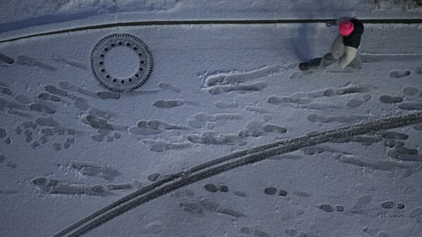 Ein Passant geht durch den Schnee in Berlin.