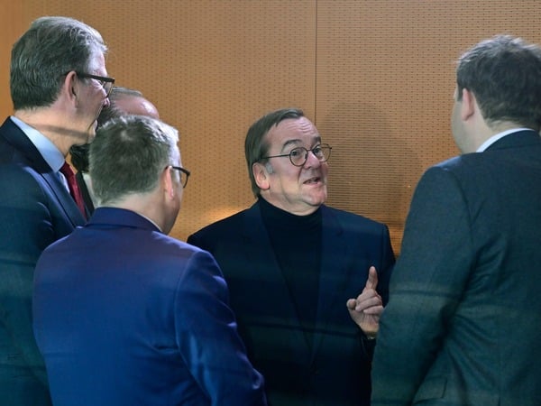 German Defence Minister Boris Pistorius (C) speaks to German Finance Minister and Vice Chancellor Lars Klingbeil (R) prior to the weekly cabinet meeting on January 7, 2026 at the Chancellery in Berlin. (Photo by John MACDOUGALL / AFP)