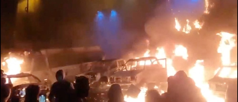 Protesters gather as vehicles burn, amid evolving anti-government unrest, in Tehran, Iran, in this screen grab obtained from a social media video released on January 9, 2026. Social Media/via REUTERS  THIS IMAGE HAS BEEN SUPPLIED BY A THIRD PARTY. NO RESALES. NO ARCHIVES.

VERIFICATION:
- Buildings, business signage and traffic light matched file and satellite imagery
- Date not verified
- Witnesses told Reuters protesters gathered in the streets on Thursday (January 8)