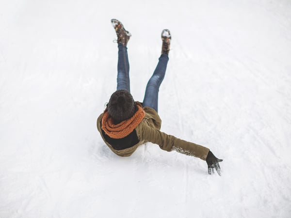 Young woman sliding down the hill ,falling down