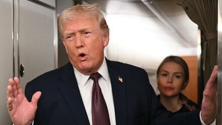 US President Donald Trump speaks to the press aboard Air Force One on January 11, 2026. Trump said Sunday his administration was working well with Venezuela's interim leader Delcy Rodriguez and that he would be open to meeting with her. (Photo by ANDREW CABALLERO-REYNOLDS / AFP)