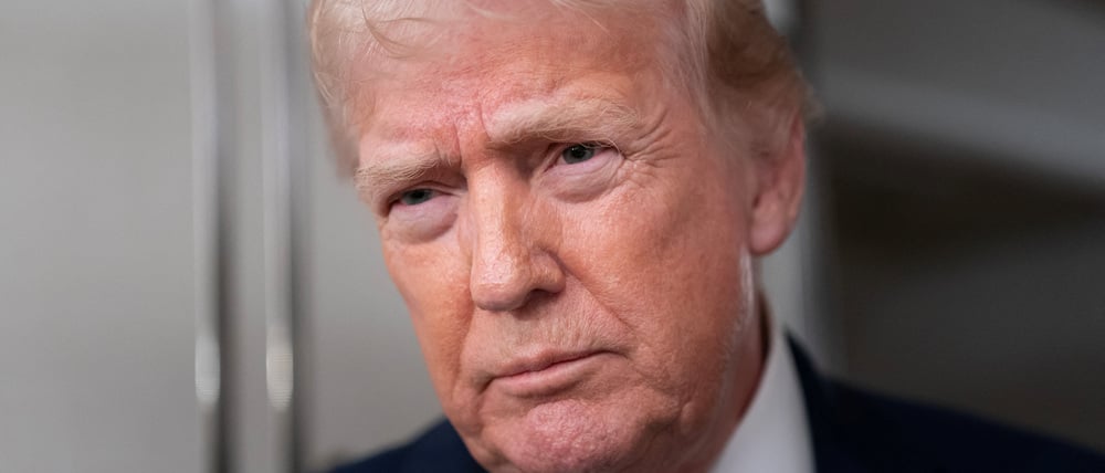 U.S. President Donald Trump speaks with members of the media aboard Air Force One en route from Florida to Joint Base Andrews, Maryland, U.S., January 11, 2026. REUTERS/Nathan Howard