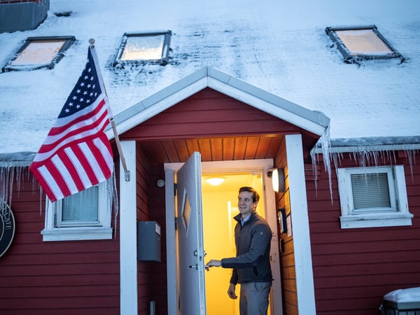An employee closes a door after he hung out the flag outside the U.S. Consulate in Nuuk, Greenland, January 13, 2026. REUTERS/Marko Djurica
