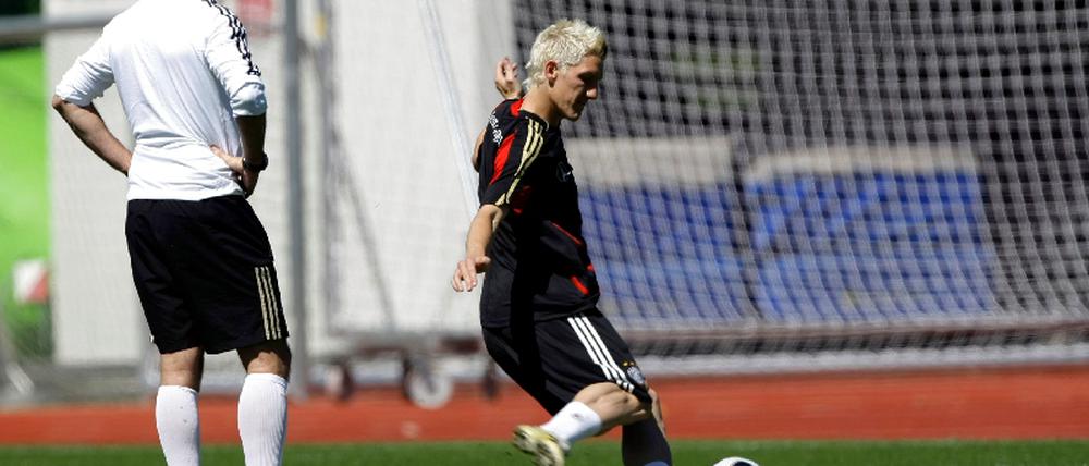 Coach Loew watches Schweinsteiger practice penalties during a training session of the German national soccer team during the Euro 2008 in Tenero