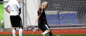 Coach Loew watches Schweinsteiger practice penalties during a training session of the German national soccer team during the Euro 2008 in Tenero