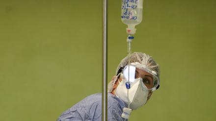 A health worker looks at an infusion bottle containing a monoclonal antibody treatment as it is being administered intravenously to a coronavirus disease (COVID-19) patient, at San Giuseppe Hospital, in Albano, Italy, April 22, 2021. REUTERS/Yara Nardi