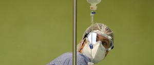 A health worker looks at an infusion bottle containing a monoclonal antibody treatment as it is being administered intravenously to a coronavirus disease (COVID-19) patient, at San Giuseppe Hospital, in Albano, Italy, April 22, 2021. REUTERS/Yara Nardi
