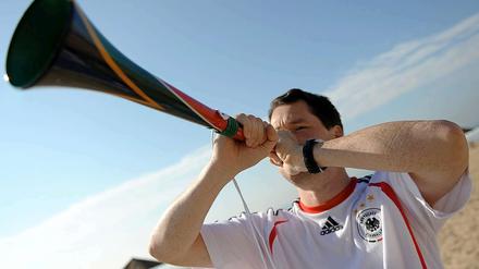 Ein Fan bläst beim Spiel Deutschland - Australien in die Vuvuzela.