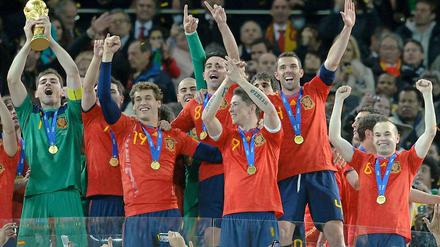 Spanien mit Pokal. Erstmals gewinnt eine europäische Mannschaft den WM-Titel außerhalb des eigenen Kontinents. Zudem hat noch nie ein WM-Titelträger sein Auftaktspiel bei einer WM verloren. Und dafür reichten dem Champion ganze acht Tore und in den vier K.o.-Spielen jeweils ein 1:0.
