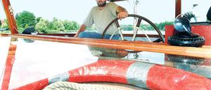 Einer dreht am Rad. Reeder Michael Kutzker im Führerhaus seines 1928 gebauten Motorschiffes „MS Rhein“.