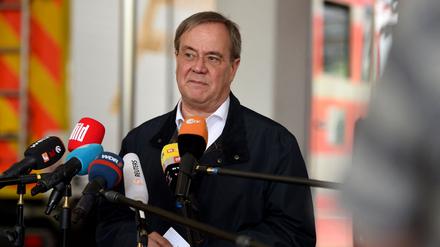 Armin Laschet, State Premier of North Rhine-Westphalia and also candidate for chancellor of his conservative CDU/CSU union for September elections, gives a statement after visiting flooded regions in Hagen, western Germany, on July 15, 2021. - Heavy rains and floods lashing western Germany have killed at least 19 people and left around 50 missing, as rising waters led several houses to collapse, police said. (Photo by INA FASSBENDER / AFP)