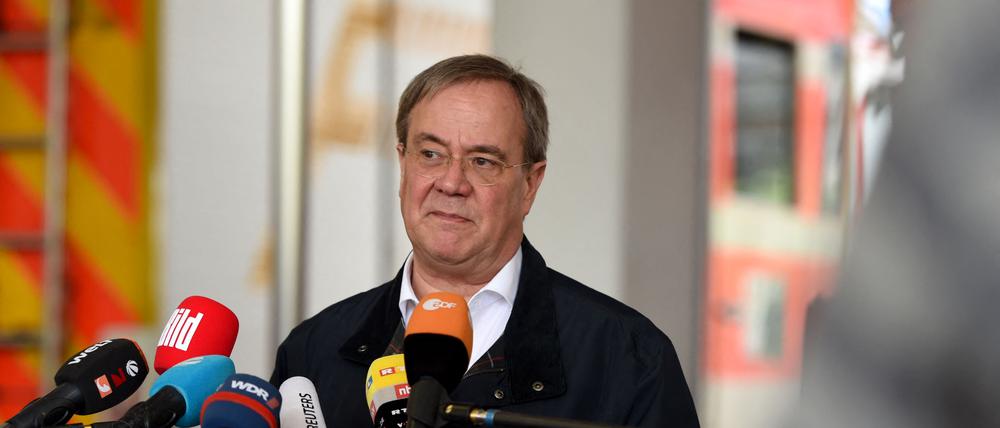 Armin Laschet, State Premier of North Rhine-Westphalia and also candidate for chancellor of his conservative CDU/CSU union for September elections, gives a statement after visiting flooded regions in Hagen, western Germany, on July 15, 2021. - Heavy rains and floods lashing western Germany have killed at least 19 people and left around 50 missing, as rising waters led several houses to collapse, police said. (Photo by INA FASSBENDER / AFP)