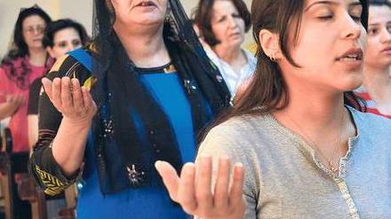 Im Exil. Mitglieder einer irakischen Flüchtlingsfamilie bei einem Gottesdienst im jordanischen Amman.