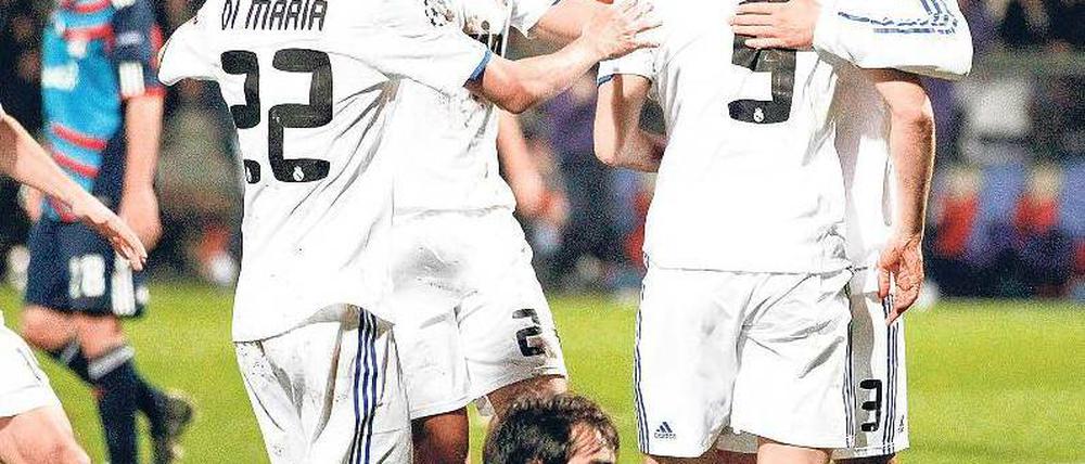 Gruppenfeiern. Mesut Özil (r.) und Sami Khedira (2. v. l. ) bejubeln mit Torschütze Karim Benzema das 1:0 von Real Madrid bei Olympique Lyon. Foto: Reuters