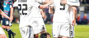 Gruppenfeiern. Mesut Özil (r.) und Sami Khedira (2. v. l. ) bejubeln mit Torschütze Karim Benzema das 1:0 von Real Madrid bei Olympique Lyon. Foto: Reuters