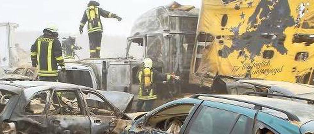 Ausgebrannt. Feuerwehrleute sind am Freitag im Einsatz auf der A 19 bei Kavelstorf in der Nähe von Rostock. Sie suchen nach weiteren Opfern.