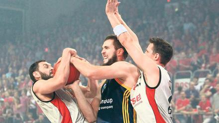 Den Traum entrissen. Die Bamberger Predrag Suput (links) und Casey Jacobsen (rechts) nehmen Alba Berlins Miroslav Raduljica den Ball – und die Hoffnung auf den Titel. Foto: dapd