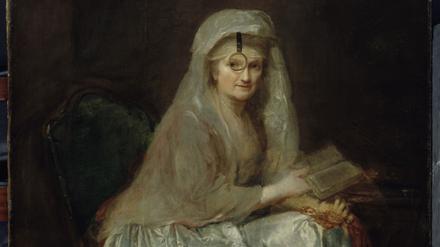 In den Blick genommen. Mit Sehhilfe malte sich Anna Dorothea Therbusch 1776/77 in ihrem Autoporträt, das heute zu den Hauptwerken der Berliner Gemäldegalerie gehört. Die Künstlerin fokussiert ihre Betrachter:innen durch ein kreisrundes Einglas.