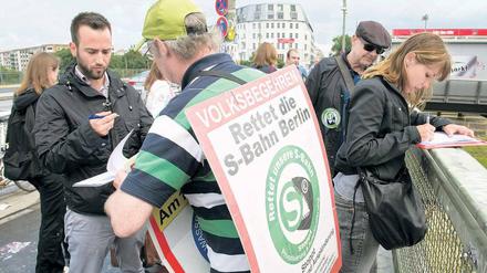 Weichenstellung. Die Initiative S-Bahn-Tisch begann am Freitag, am S-Bahnhof Warschauer Straße Unterschriften zu sammeln. Sie will mit einem Volksbegehren erreichen, dass künftig mehr Züge fahren und wieder Personal für die Bahnhöfe eingestellt wird. Foto: Ecopix