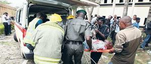 Tote und Verletzte. Helfer tragen ein Opfer des Anschlags von Abuja in einen Rettungswagen. Foto: Afolabi Sodtunde/Reuters