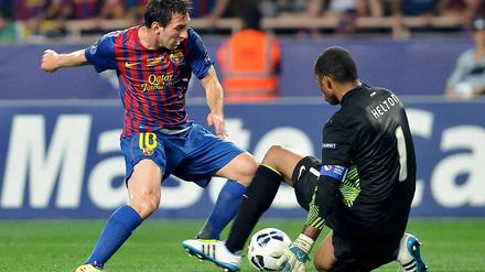 Weltfußballer Lionel Messi (l.) umkurvt Helton, den Torhüter des FC Porto, kurz bevor er das Spielgerät zur 1:0-Führung einschiebt.