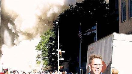 Alles flüchtet. Fußgänger laufen vor einem der einstürzenden Zwillingstürme des World Trade Center davon. Bei dem Massenmord starben rund 3000 Menschen.
