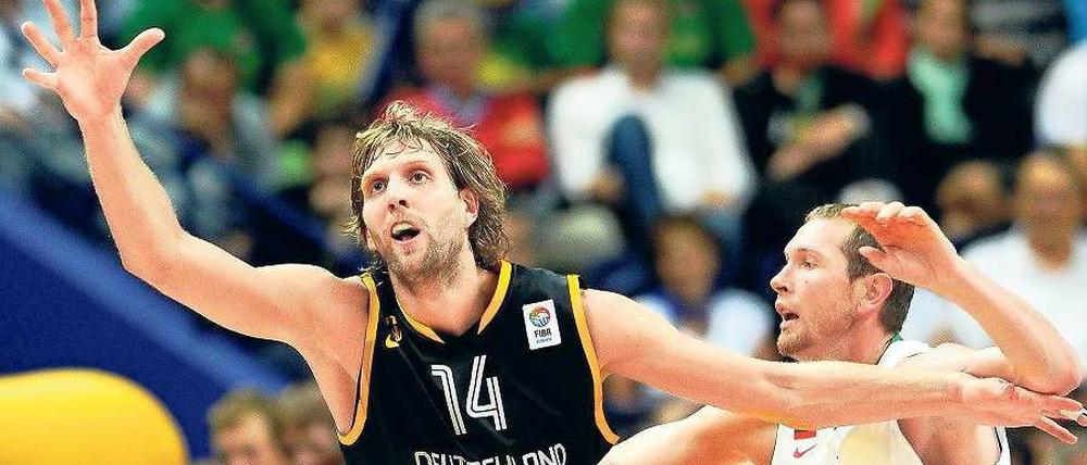 Nicht immer auf Ballhöhe. Dirk Nowitzki (li.) und Gegenspieler Darius Songaila. Foto: dpa