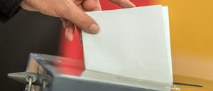 Ein Wähler wirft seinen Stimmzettel zur Bundestagswahl in die Wahlurne. 