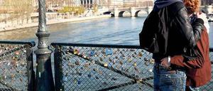 Treueschwüre. Liebespaar auf dem mit Schlössern vollgehängten Pont des Art in Paris. Foto: Pierre Hounsfield/Allpix/laif