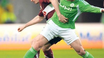 Rangelei mit Anfassen. Der Wolfsburger Ja-Cheol Koo (r. ) und Stuttgarts Spieler William Kvist konnten nicht glänzen. Foto: dpa