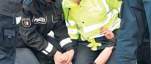 Polizisten nehmen in Leck einen gewalttätigen Demonstranten fest. Foto: dpa