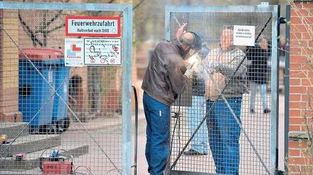Dicht machen. Das Eingangstor zur Humboldthain-Grundschule wurde am Donnerstag mit einer Platte gesichert. Von dem Täter, der bereits am 1. März ein Mädchen missbrauchte, fehlt bisher jede Spur.