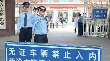 Im Visier der Polizei. Vor dem Pekinger Chaoyang-Krankenhaus, in dem sich der Menschenrechtsaktivist Chen und seine Familie befinden, filmt ein Polizeibeamter ausländische Journalisten. Foto: Mark Ralston/AFP