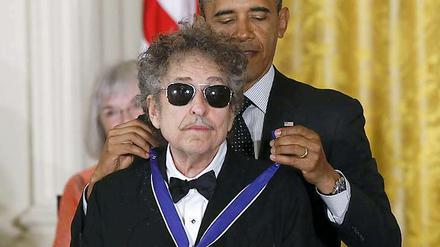 Wie eine Katze, der der Kopf gewaschen wird: Ein weniger widerwillig schien Bob Dylan sich von Barack Obama die "Medal of Freedom" umlegen zu lassen.