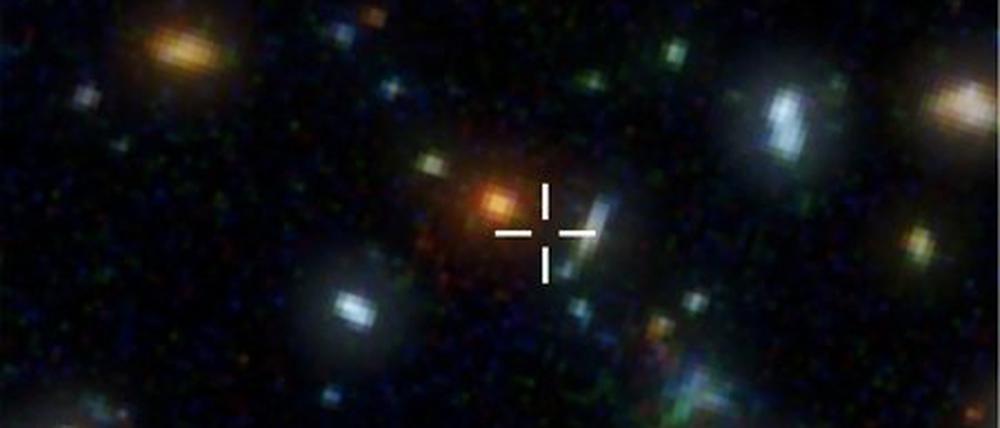 Ganz weit draußen. Das Bild zeigt einen Ausschnitt aus dem Hubble Deep Field mit vielen, weit entfernten Galaxien. Die Submillimeter-Galaxie HDF 850.1 befindet sich an der markierten Stelle. Im optischen Bereich ist sie allerdings nicht sichtbar. Sie lässt sich nur mit Radioteleskopen nachweisen.