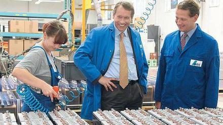 Detailarbeit. Dafür interessieren sich Senator Ulrich Nußbaum, parteilos, und IHK-Präsident Eric Schweitzer (rechts) beim Batteriehersteller BAE. Am Mittwoch besuchten sie mit SPD-Fraktionschef Raed Saleh mittelständische Unternehmen.