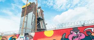 Kunst vorm Bau. Der Schutzzaun, der die Baustelle der neuen EZB-Zentrale umgibt, erinnert ein wenig an die Berliner Mauer – jedenfalls aus künstlerischer Sicht scheint er ähnlich attraktiv zu sein. Foto: dpa