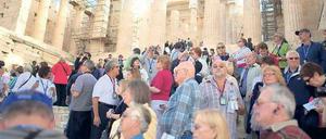 Anziehungspunkt. Urlauber drängen sich an den Propyläen der Akropolis. 