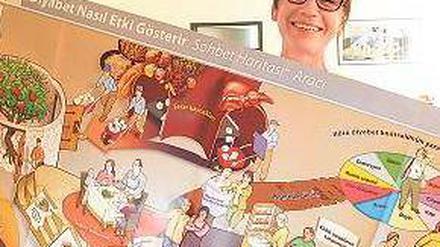 Poster. Ernährungsberaterin Ilse Christodolou zeigt das Schulungsmaterial.