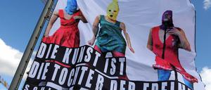 Auf dem Dach des Berliner Ensembles weht eine Fahne, welche die Musikerinnen von Pussy Riot bei ihrer Aktion in der Moskauer Erlöserkathedrale, dazu ein Satz Schillers: "Die Kunst ist die Tochter der Freiheit."