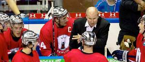 Berlins Trainer Don Jackson (2.v.r.), hier beim Spiel gegen die Hamburg Freezers, spricht während einer Auszeit mit seinen Spielern.